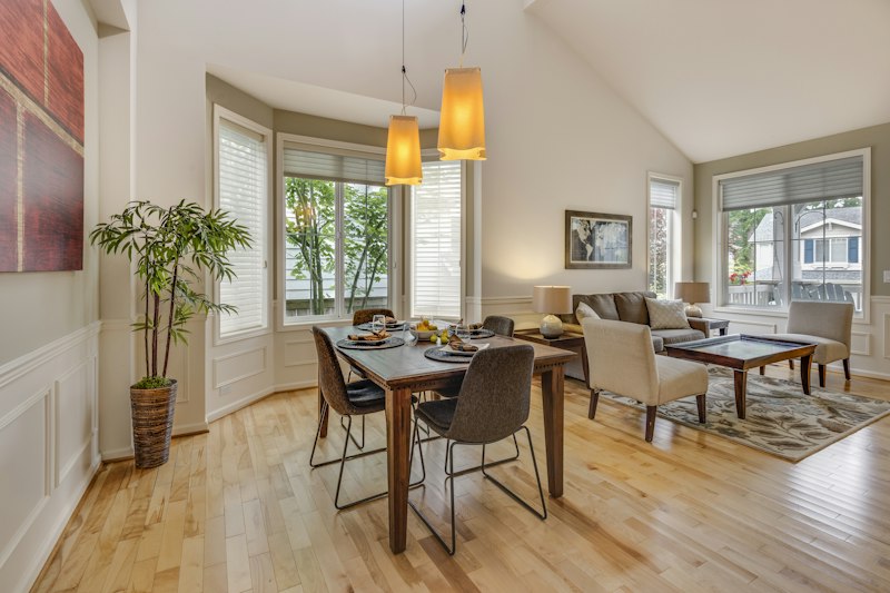 A wooden dining table and chairs in a bright room